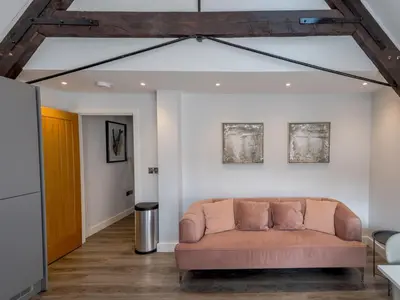 a couch in the middle of a living room at Dahlia Contemporary town centre apartment - Pass the Keys in Shrewsbury