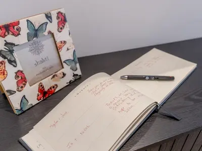 a notebook and pen on a table next to a box at 1 bed Albury Contemporary Apartment with Secure Parking - Pass the Keys in Shrewsbury