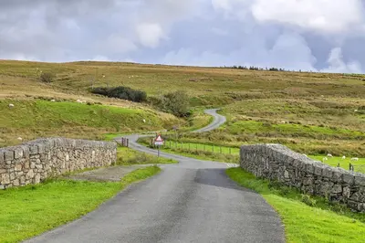a winding road in the middle of a field at Finest Retreats - Mountain View in Trawsfynydd
