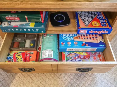 a drawer filled with lots of toys and games at Cysgod Y Coed in Llanbedr