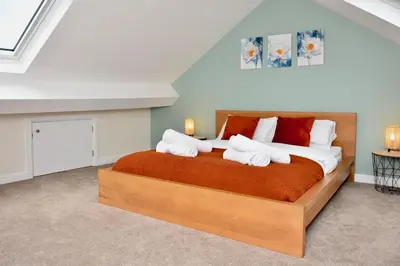 a bedroom with a large bed with towels on it at Cosy yet spacious, 3BR, Parking, Village Location in Oswestry