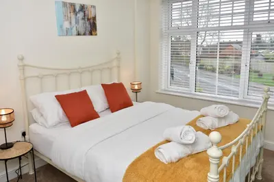 a bedroom with a white bed with towels on it at Cosy yet spacious, 3BR, Parking, Village Location in Oswestry