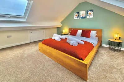 a bedroom with a large bed with towels on it at Cosy yet spacious, 3BR, Parking, Village Location in Oswestry