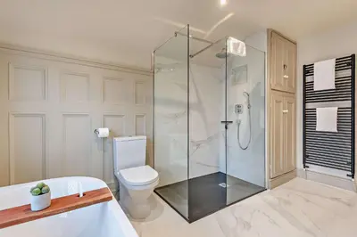 a bathroom with a shower and a toilet and a tub at Shrewsbury Townhouse - Free Parking in Shrewsbury