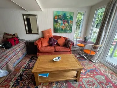 a living room with a couch and a coffee table at The Garden Room in Knighton
