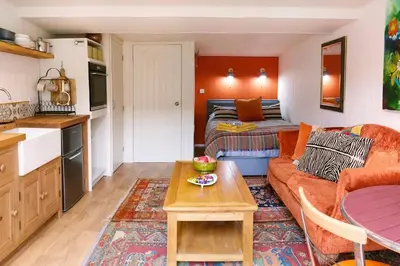 a living room with a couch and a table at The Garden Room in Knighton