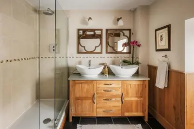 a bathroom with two sinks and a shower at Meadow End Barn in Dorstone
