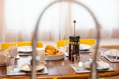 a wooden table with a plate of food on it at Bullrush Barn, Brecon Beacons walkers retreat in Brecon