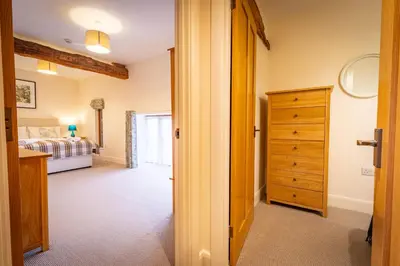 a bedroom with a bed and a dresser in a room at Marina View, Near Canal and Mountains in Brecon