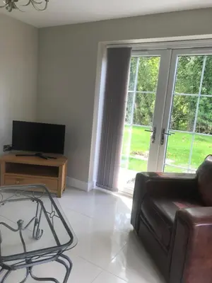 a living room with a couch and a television at Haul y Bore in Aberystwyth