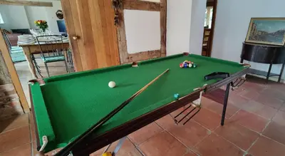 a pool table in a living room with afits at Gaer Hall Guilsfield a country mansion with hottub in Welshpool