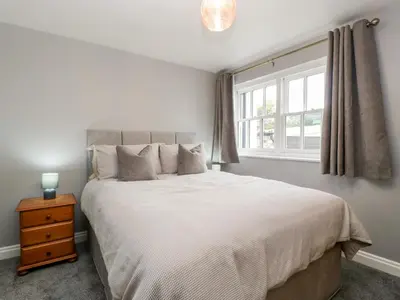 a bedroom with a large bed and a window at 19 Lion Street in Hereford