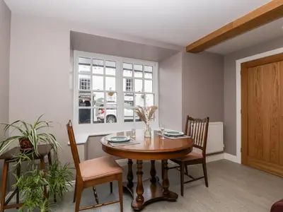 a dining room with a table and chairs and a window at 19 Lion Street in Hereford