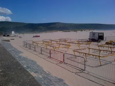 a beach with a bunch of bars on the sand at Tal Y Don Hotel in Barmouth