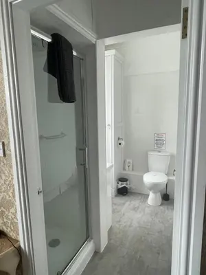 a bathroom with a shower and a toilet at Tal Y Don Hotel in Barmouth