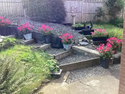 a garden with some potted plants and flowers at Cartref Bach in Llanybydder