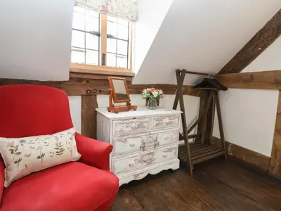 a red chair and a dresser in a room at 18 Church Street in Llangollen