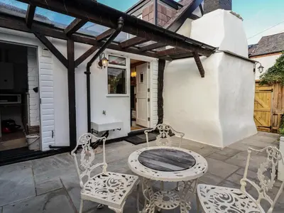 a patio with a table and chairs on a patio at 18 Church Street in Llangollen