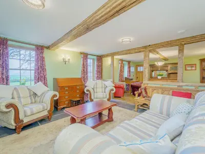 a living room with couches and chairs and a table at The Druids in Corwen