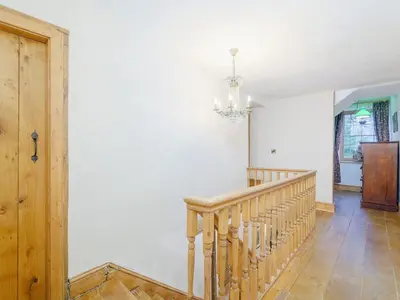 a room with a staircase and a chandelier at The Druids in Corwen