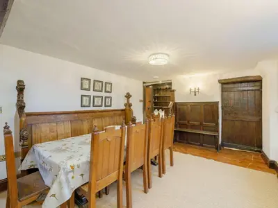 a dining room with a table and a group of chairs at The Druids in Corwen