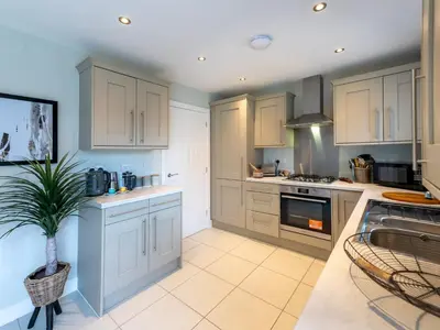 a kitchen with white cabinets and a potted plant at Contemporary 2 bedroom home - Pass the Keys in Ludlow