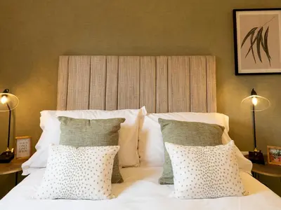 a bedroom with a white bed with two pillows at Contemporary 2 bedroom home - Pass the Keys in Ludlow
