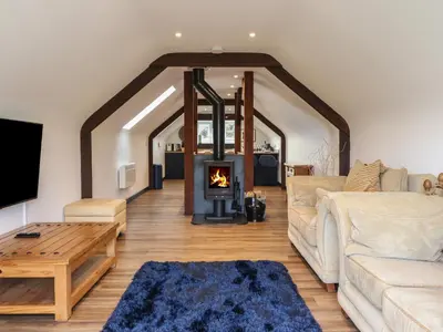 a living room with a couch and a fireplace at Bryn Eglwys Cottage in Tywyn