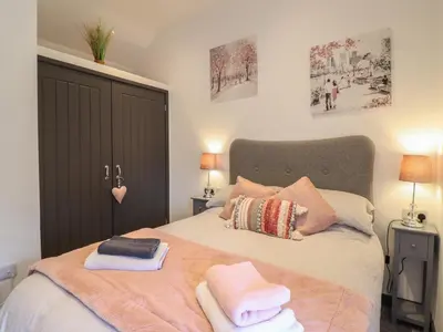 a bedroom with a bed with towels on it at Bryn Eglwys Barn in Tywyn