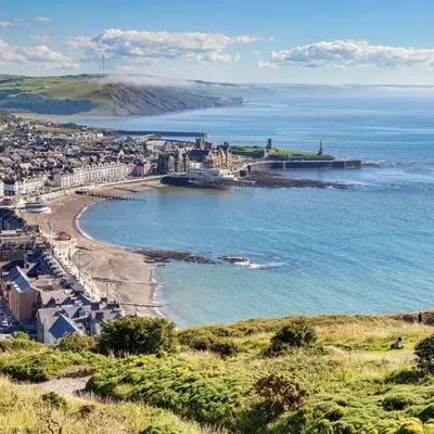 a view of a beach with a city and the ocean at Swn Y Mor 4 Aberystwyth in Aberystwyth