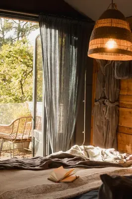 a bedroom with a bed and a window with a chair at The Boatshed at Camp Plas in Welshpool