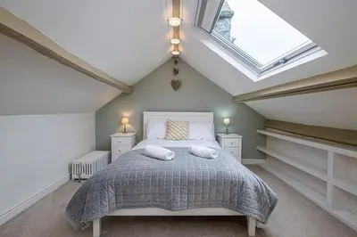 a bedroom with a bed with two pillows on it at Ty Mawr Llanfair in Llanfair