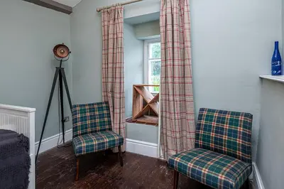 a room with two chairs and a window at Ty Mawr Llanfair in Llanfair