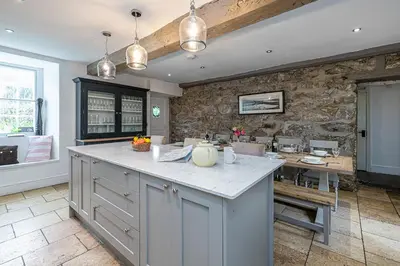 a kitchen with a large island with a counter top at Ty Mawr Llanfair in Llanfair