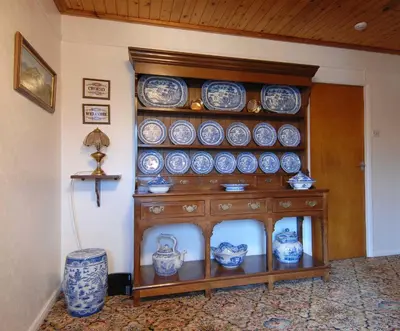 a shelf filled with blue and white dishes on a wall at Dwy Olwyn in Dolgellau