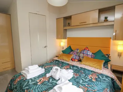 a bedroom with a bed with towels on it at 95 Hafan Taffy in Llanina