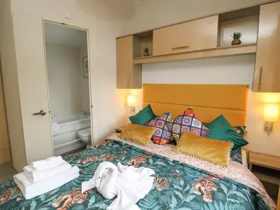 a hotel room with a bed with towels on it at 95 Hafan Taffy in Llanina