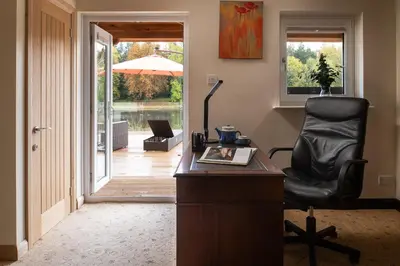 an office with a chair and a desk with a desk at Lake House in Brecon