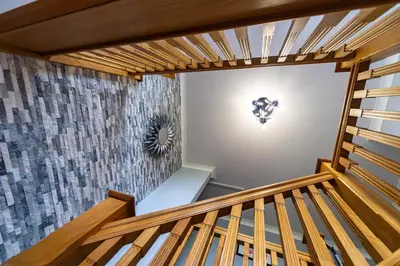 a wooden staircase in a room with a wall at Parc Y Deri in Aberystwyth