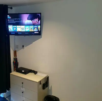 a flat screen tv hanging on a wall at Idyllic 2 Bedroom Self-Contained UpsideDown Annexe in Llandrindod Wells