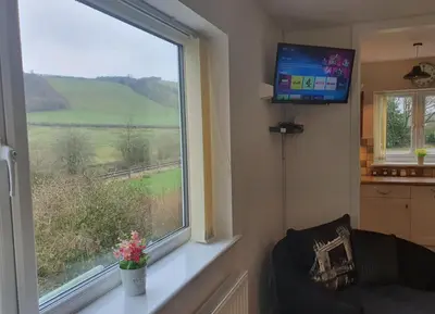 a living room with a window and a tv at Idyllic 2 Bedroom Self-Contained UpsideDown Annexe in Llandrindod Wells