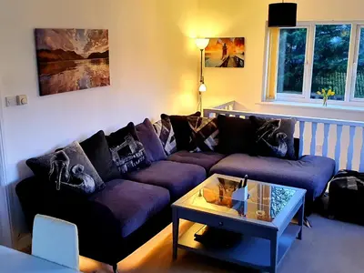 a living room with a purple couch and a table at Idyllic 2 Bedroom Self-Contained UpsideDown Annexe in Llandrindod Wells