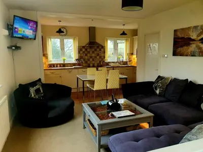 a living room with a couch and a table at Idyllic 2 Bedroom Self-Contained UpsideDown Annexe in Llandrindod Wells