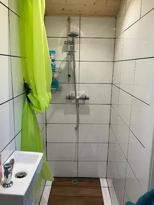 a bathroom with a sink and a shower at Transformed Railway Wagon- Sleeps2-Garden-Firepit in Crickhowell