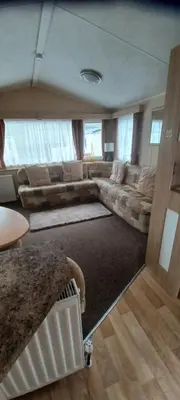 a living room with a couch and a table at Caravan 76 snowdon summit 016 in Talybont