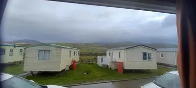 a view from a window of a group of mobile homes at Caravan 76 snowdon summit 016 in Talybont