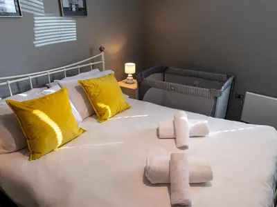 a bedroom with a bed with towels on it at Modern flat a short walk from Shrewsbury centre - Pass the Keys in Shrewsbury