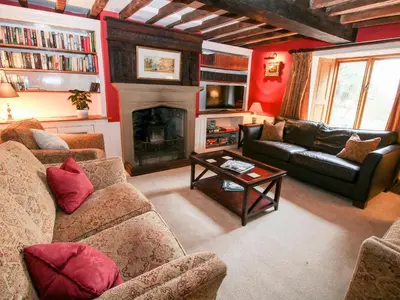 a living room with two couches and a fireplace at Pentre Hall in Oswestry