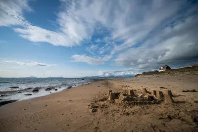 a sand castle on a beach near the ocean at Stabal-Byrdir in Dyffryn