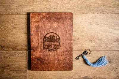 a wooden door with a key on a table at Cosy Shepherd's Hut with Hot Tub in Church Stretton